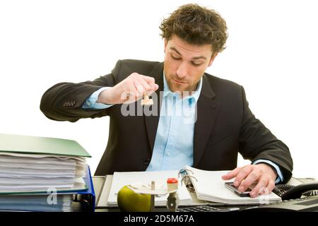 Young man in a suit is working at his desk Stock Photo