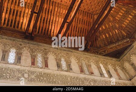 Intricately patterned wooden artesonado ceiling and stucco decoration.  Synagogue of El Tránsito (Sinagoga del Tránsito), founded in the 1350’s. Toled Stock Photo