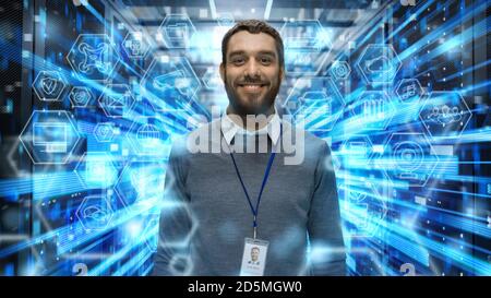 Shot of a Smiling IT Engineer Standing in the Middle of a Working Data Center Server Room. Visualizations of Data Transmission Through High Speed Stock Photo