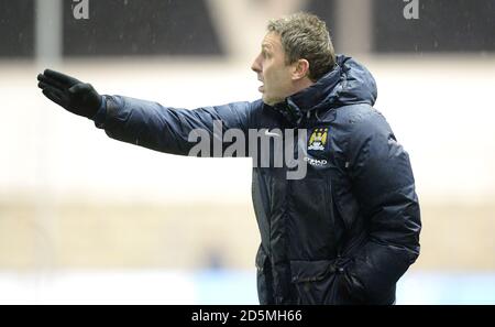 Manchester City academy manger Jason Wilcox shouts instructions to his players against Stoke City Stock Photo