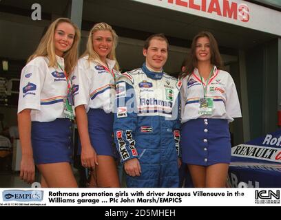 Rothmans promotion girls with driver Jacques Villeneuve in the Williams garage Stock Photo