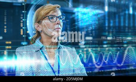 Female IT Engineer Identified by Biometric Facial Recognition Scanning Process in Data Center Server Room. Futuristic Concept: Projector Identifies Stock Photo