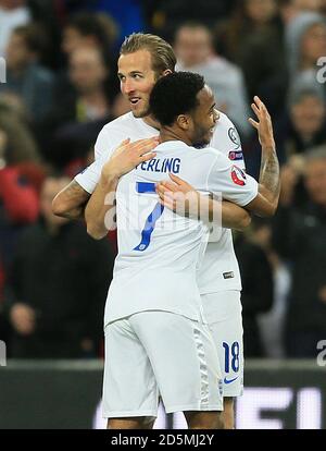 England's Harry Kane (left) celebrates with Raheem Sterling after scoring against Lithuania. Stock Photo