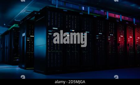 Descending Shot of Data Center With Multiple Rows of Fully Operational Server Racks. Modern Telecommunications, Cloud Computing, Artificial Stock Photo