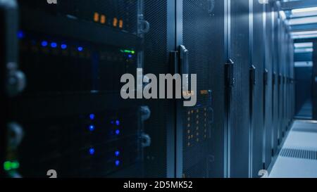 Close-up Shot of Data Center With Rows of Fully Operational Server Racks. Concept of Telecommunications, Cloud Computing, Artificial Intelligence Stock Photo