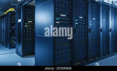 Shot of Modern Data Center With Multiple Rows of Operational Server Racks. Modern High-Tech Database Super Computer Clean Room. Stock Photo