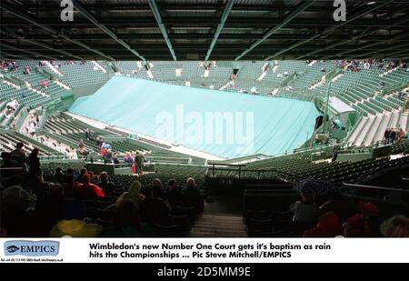 Wimbledon's new Number One Court gets it's baptism as rain hits the Championships  Stock Photo