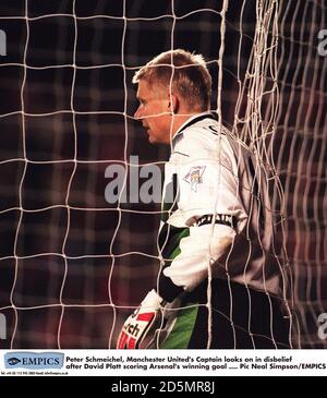 Manchester United goalkeeper Peter Schmeichel looks out from his goal after conceding the winning goal to Arsenal's David Platt Stock Photo