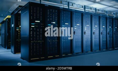 Shot of Data Center With Multiple Rows of Fully Operational Server Racks. Modern Telecommunications, Cloud Computing, Artificial Intelligence Stock Photo