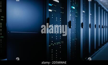 Shot of Data Center With Multiple Rows of Fully Operational Server Racks. Modern Telecommunications, Cloud Computing, Artificial Intelligence Stock Photo