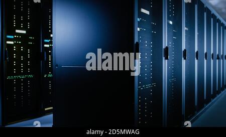 Shot of Data Center With Multiple Rows of Fully Operational Server Racks. Modern Telecommunications, Cloud Computing, Artificial Intelligence Stock Photo