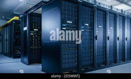 Shot of Data Center With Multiple Rows of Fully Operational Server Racks. Modern Telecommunications, Cloud Computing, Artificial Intelligence Stock Photo