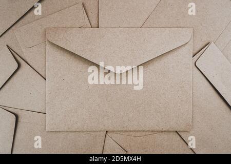 Top view of Brown paper envelope. Flat lay of Many brown paper envelopes overlaid. Stationery minimalism style. Stock Photo