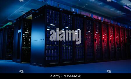 Shot of Data Center With Multiple Rows of Fully Operational Server Racks. Modern Telecommunications, Artificial Intelligence, Supercomputer Technology Stock Photo