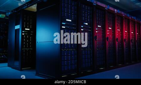 Shot of Data Center With Multiple Rows of Fully Operational Server Racks. Modern Telecommunications, Artificial Intelligence, Supercomputer Technology Stock Photo