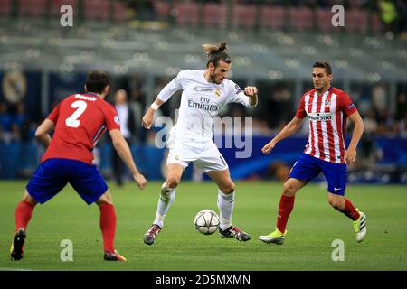 Real Madrid's Gareth Bale (centre) and Atletico Madrid's Koke (right) in action Stock Photo