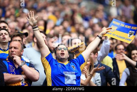 AFC Wimbledon fans show their support in the stands. Stock Photo