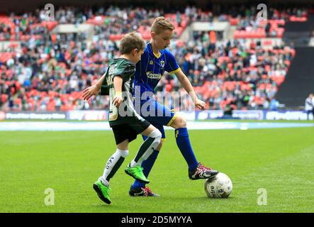 The Plymouth Argyle and AFC Wimbledon mascots play football on the