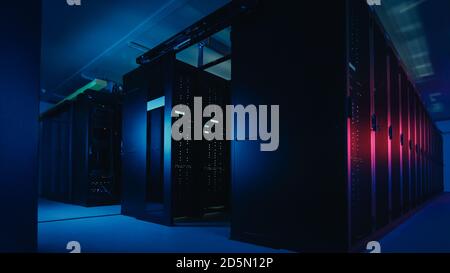 Shot of Data Center With Multiple Rows of Fully Operational Server Racks. Modern Telecommunications, Cloud Computing, Artificial Intelligence Stock Photo