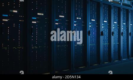Shot of Dark Data Center With Multiple Rows of Fully Operational Server Racks. Modern Telecommunications, Cloud Computing, Artificial Intelligence Stock Photo