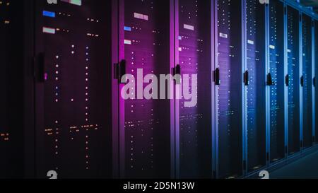 Shot of Dark Data Center With Multiple Rows of Fully Operational Server Racks. Modern Telecommunications, Cloud Computing, Artificial Intelligence Stock Photo