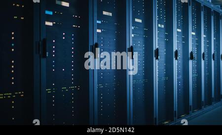 Shot of Dark Data Center With Multiple Rows of Fully Operational Server Racks. Modern Telecommunications, Cloud Computing, Artificial Intelligence Stock Photo