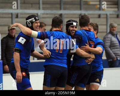 France's Romain Buros (third left) celebrates after he scores his sides fifth try during the Under 20's Rugby Union World Cup match at the AJ Bell Stadium, Salford. Stock Photo