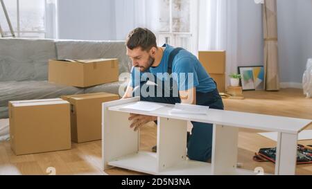 Professional Furniture Assembly Worker Assembles Shelf. Professional Handyman Doing Assembly Job Well, Helping People who Move into New House. Stock Photo