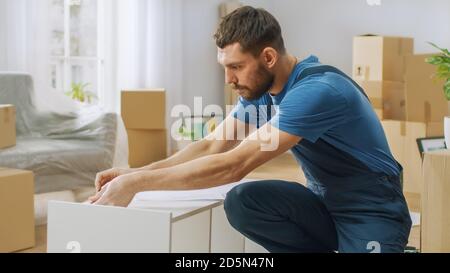 Furniture Assembly Worker Assembles Bookshelf. Professional Handyman Doing Assembly Job Well, Helping People who Move into New House. Stock Photo