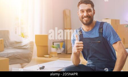 Successful Furniture Assembly Worker Finishes Assembling Shelf and Shows Thumbs Up Smilingly. Professional Handyman Doing Assembly Job Well. Room Lit Stock Photo