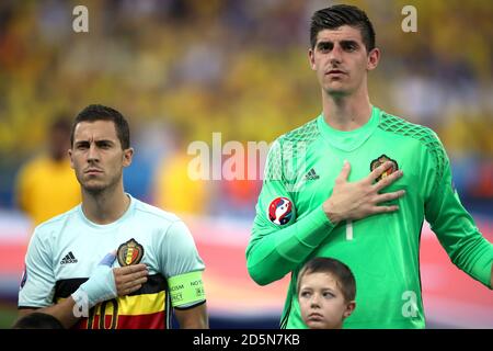 Belgium's Eden Hazard and goalkeeper Thibaut Courtois (right) during the national anthem  Stock Photo