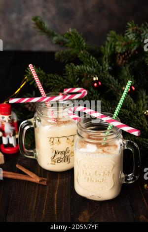 Traditional Christmas drink eggnog into glass mug Stock Photo