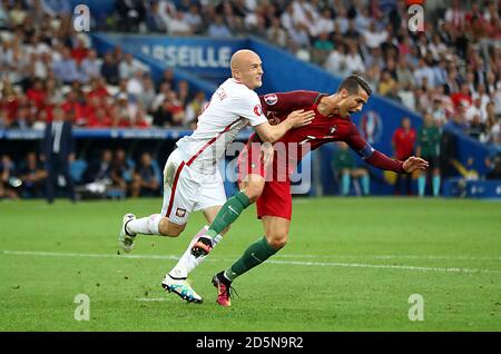 Poland's Michal Pazdan (left) and Portugal's Cristiano Ronaldo battle for the ball Stock Photo