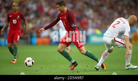 Portugal's Cristiano Ronaldo and Poland's Michal Pazdan battle for the ball Stock Photo