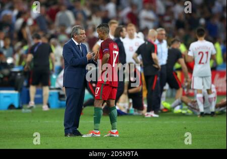 Portugal Manager Fernando Santos speaks with Portugal's Nani during half time of extras time. Stock Photo