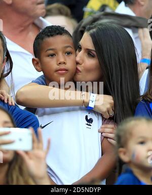 Ludivine Sagna, wife of France's Bacary Sagna and their son Elias in the stands before the game. Stock Photo