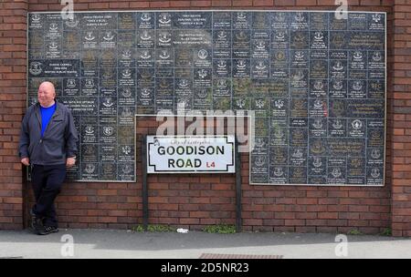 An Everton fan waits outside Goodison Park before the Barclays Premier League game between Everton and Tottenham Hotspur. Stock Photo