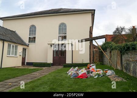 Floral tributes laid in front of a cross erected outside Chinnor Community Church in Chinnor, Oxfordshire, in memory of Zoe Powell, 29, and her three children - Phoebe, eight, Simeon, six, and Amelia, four - who were killed in a car accident on the A40 near Oxford on Monday night. Stock Photo