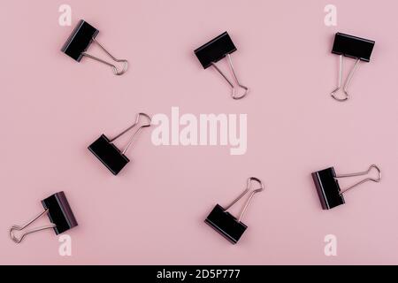 seven stationery clips isolated on pink background Stock Photo