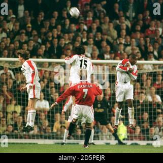 Manchester United's David Beckham (centre) smashes a free kick into the Liverpool wall of (left-right) Steve McManaman, Patrik Berger and Paul Ince Stock Photo