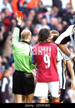 Referee Mike Riley shows a red card to Newcastle United's Celestine Babayaro Stock Photo