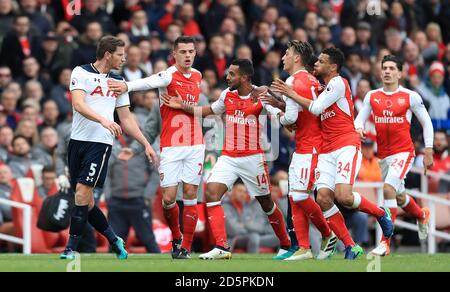 Tottenham Hotspur's Jan Vertonghen (left) and Arsenal's Theo Walcott (centre) exchange words Stock Photo