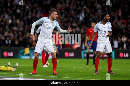 England's Jamie Vardy (left) celebrates scoring his side's second goal with Raheem Sterling Stock Photo