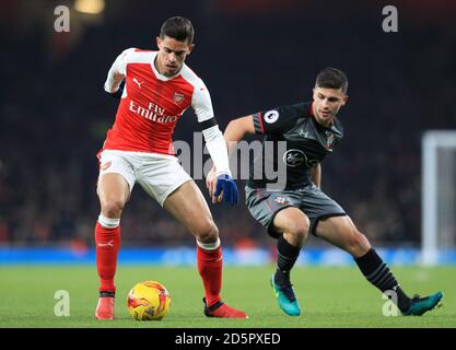 Arsenal's Gabriel Paulista (left) and Southampton's Shane Long in action Stock Photo