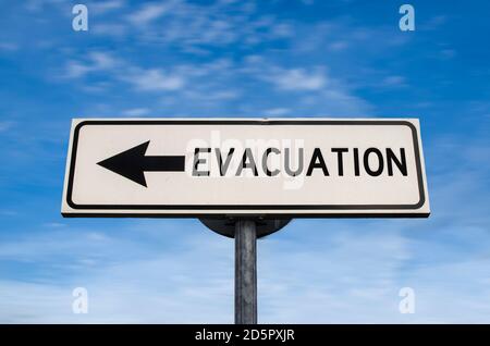 Evacuation road sign, arrow on blue sky background. One way blank road sign with copy space. Arrow on a pole pointing in one direction. Stock Photo