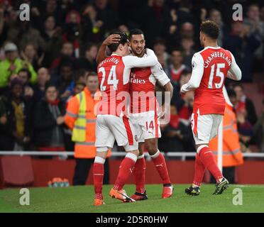 Arsenal's Theo Walcott (centre) celebrates scoring their first goal with Hector Bellerin (left) and Alex Oxlade-Chamberlain Stock Photo