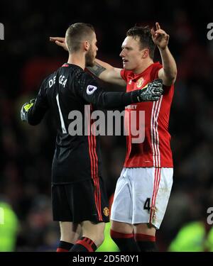 Manchester United goalkeeper David De Gea (left) celebrates with team-mate Phil Jones after the game Stock Photo