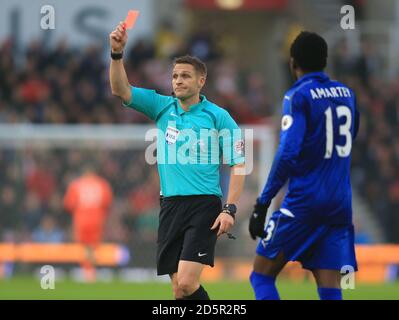 Referee Craig Pawson shows Leicester City's Jamie Vardy (out of picture) a red card Stock Photo