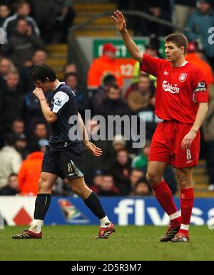 Manchester City's Joey Barton walks off the field after being dismissed as Liverpool's  Steven Gerrard looks on Stock Photo