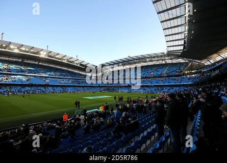 Fans take their seats at the Etihad Stadium before the game